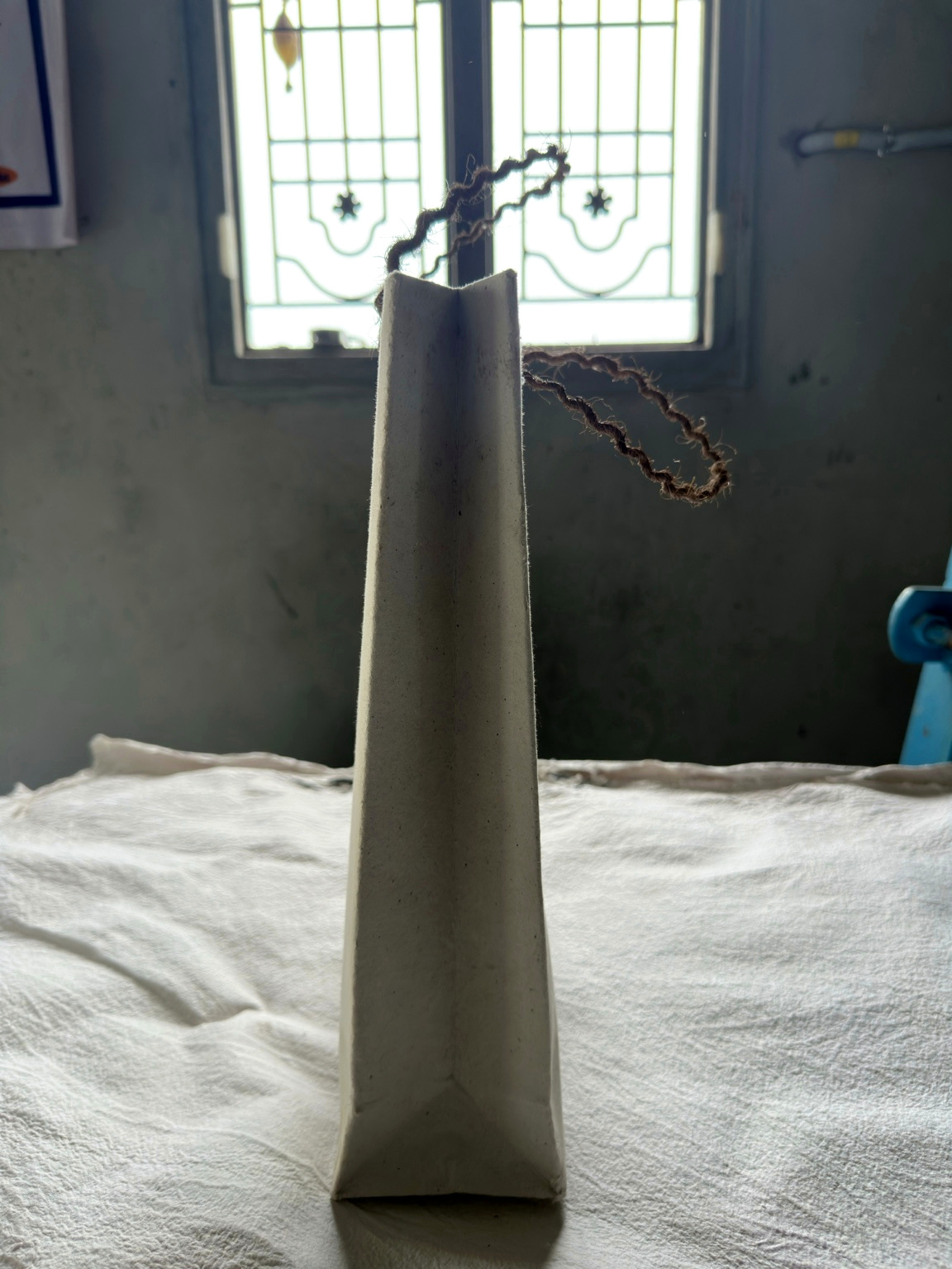 Handmade sheets laid out to dry across the workshop floor